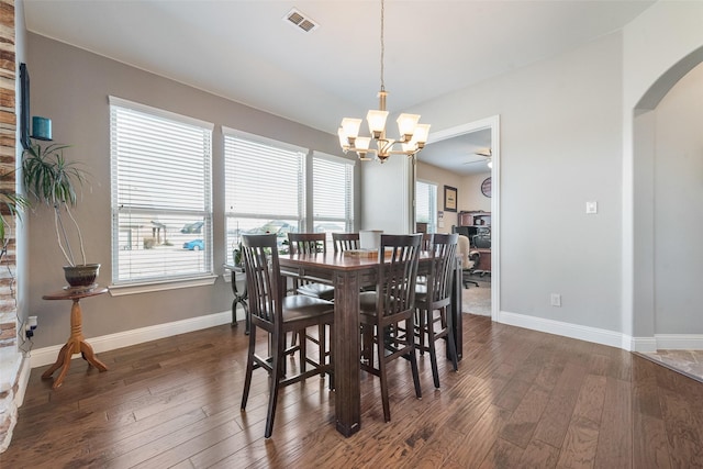 dining room featuring dark hardwood / wood-style floors and a chandelier