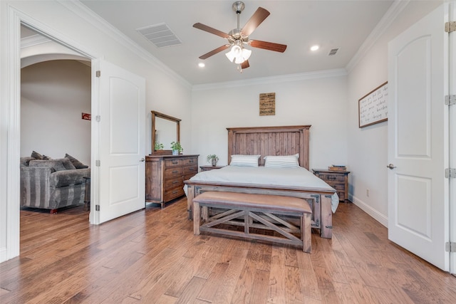 bedroom with ceiling fan, wood-type flooring, and crown molding