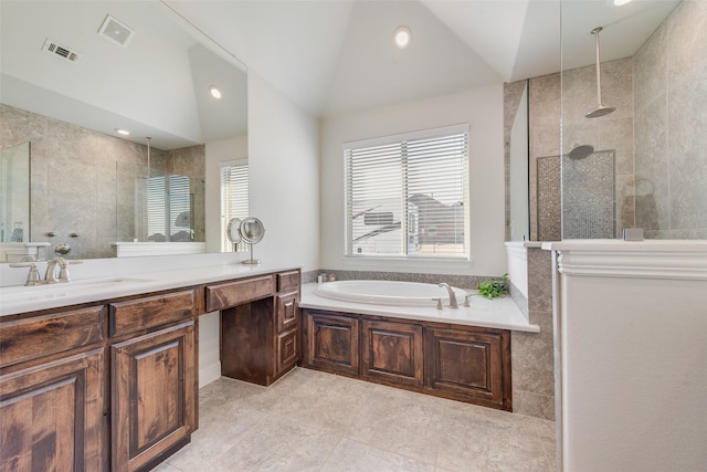 bathroom featuring separate shower and tub, vanity, and vaulted ceiling