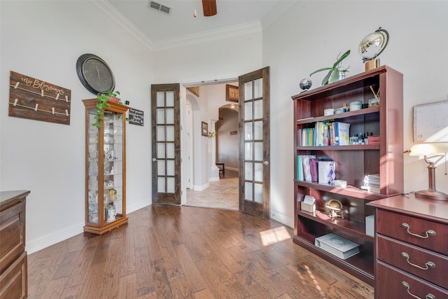 interior space with ceiling fan, french doors, ornamental molding, and hardwood / wood-style floors