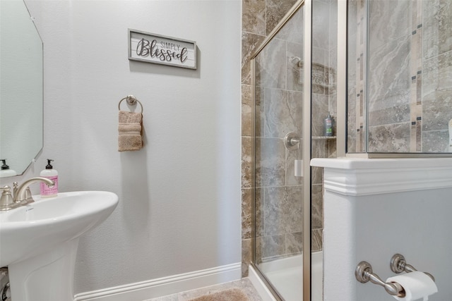 bathroom featuring walk in shower and sink