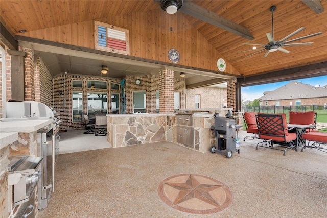 view of patio / terrace featuring ceiling fan, area for grilling, and an outdoor bar