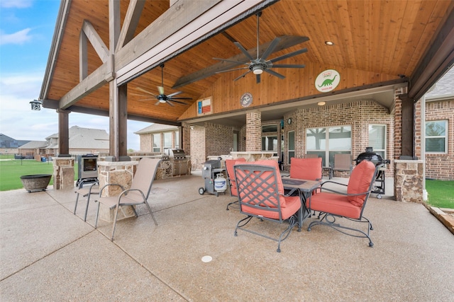 view of patio / terrace featuring ceiling fan and an outdoor kitchen