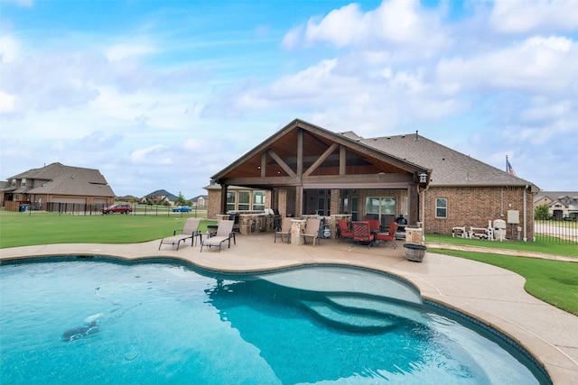 view of pool featuring a bar, a yard, and a patio