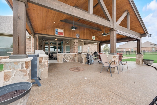 view of patio with ceiling fan, an outdoor bar, a gazebo, and area for grilling