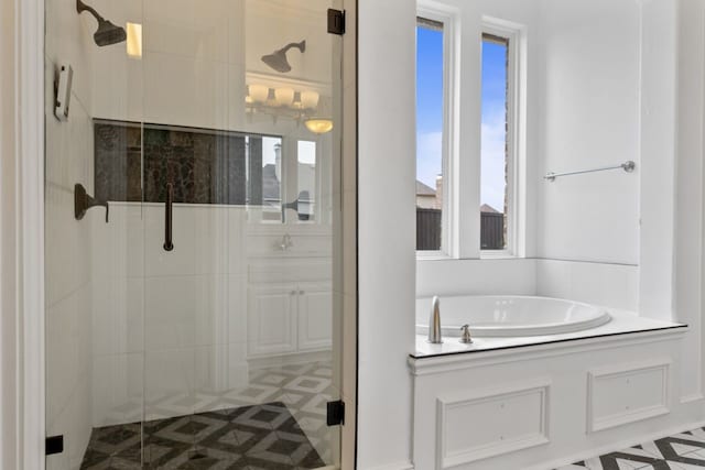 bathroom with plenty of natural light and separate shower and tub