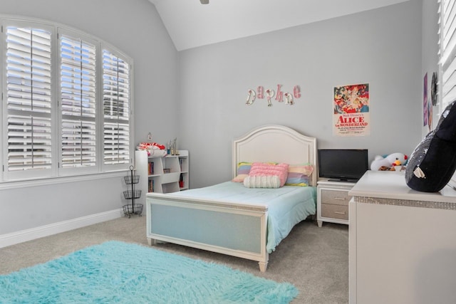 carpeted bedroom with vaulted ceiling and multiple windows