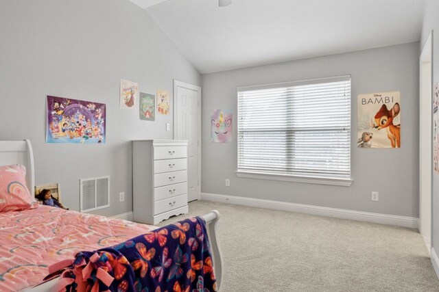 carpeted bedroom with lofted ceiling