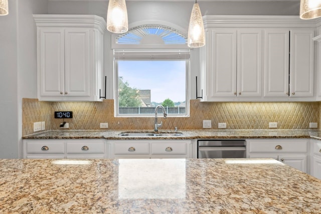 kitchen with backsplash, sink, pendant lighting, and white cabinets