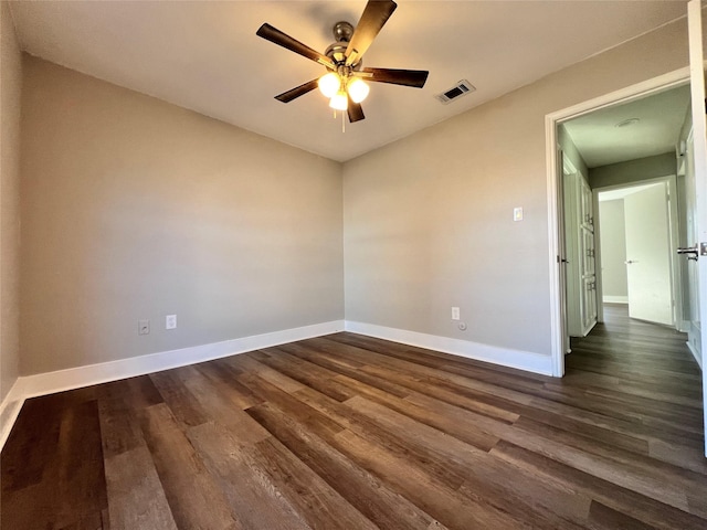 spare room with ceiling fan and dark hardwood / wood-style floors