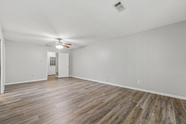 empty room with hardwood / wood-style flooring and ceiling fan