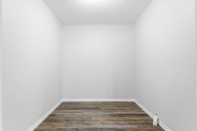 empty room with dark wood-type flooring