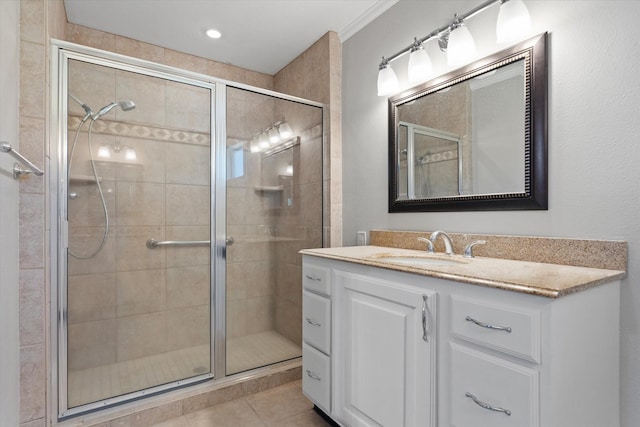 bathroom with an enclosed shower, vanity, and tile patterned flooring