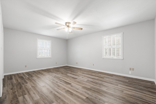 empty room with ceiling fan and dark wood-type flooring