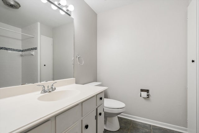 bathroom featuring tile patterned flooring, toilet, vanity, and walk in shower