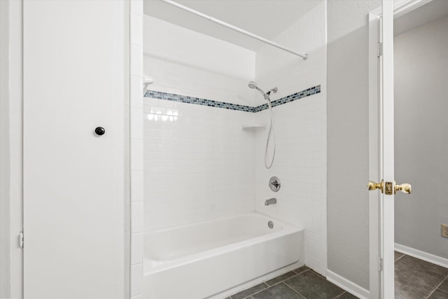 bathroom featuring tiled shower / bath and tile patterned floors