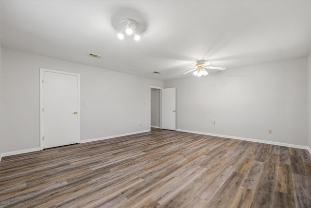 unfurnished room with ceiling fan and hardwood / wood-style flooring