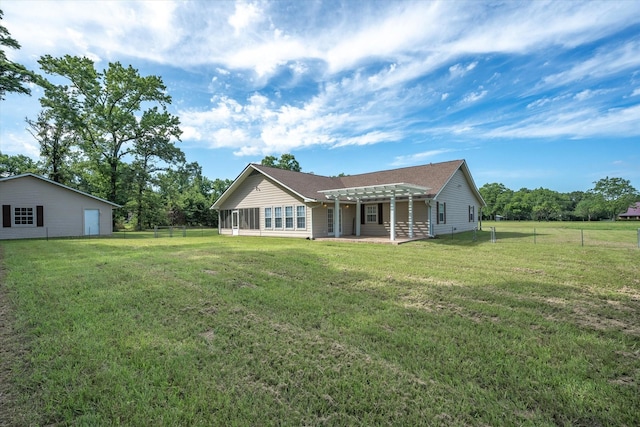 back of property with a pergola and a lawn