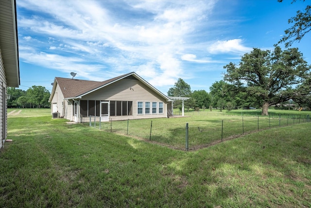 back of property featuring a lawn and a pergola