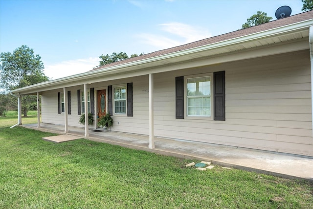 exterior space with covered porch and a front yard