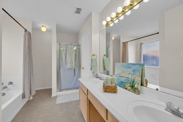 bathroom featuring vanity, tile patterned flooring, plus walk in shower, and a textured ceiling