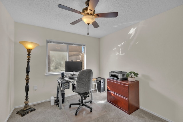 office space with ceiling fan, a textured ceiling, and light carpet