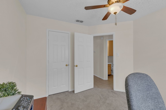 carpeted office space with a textured ceiling