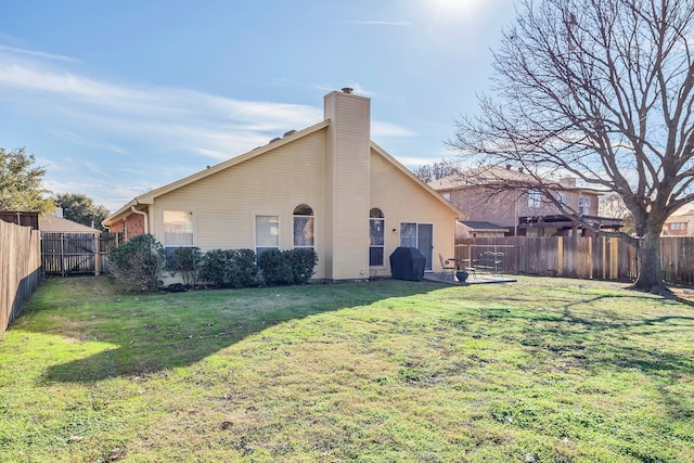 back of property featuring a yard