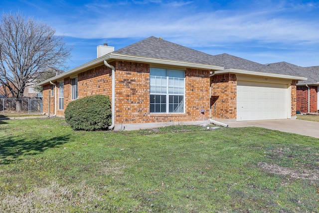 ranch-style home with a front yard and a garage