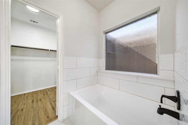 bathroom featuring a tub and hardwood / wood-style floors