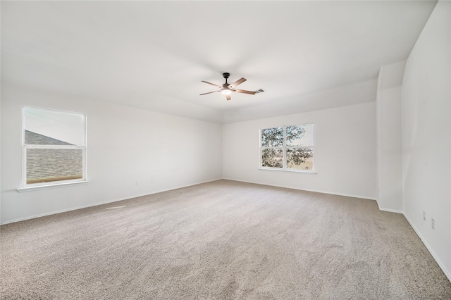 carpeted spare room with ceiling fan