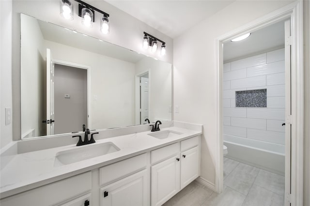 full bathroom featuring toilet, vanity, tiled shower / bath combo, and tile patterned flooring