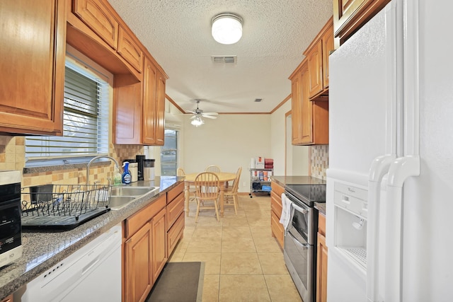 kitchen featuring ceiling fan, backsplash, white appliances, light tile patterned flooring, and sink