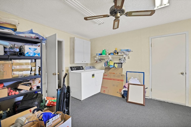 washroom featuring cabinets, a textured ceiling, washing machine and clothes dryer, and dark colored carpet