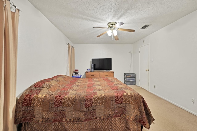 bedroom featuring a textured ceiling, ceiling fan, and carpet flooring