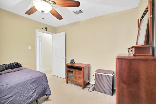 bedroom with ceiling fan and light carpet