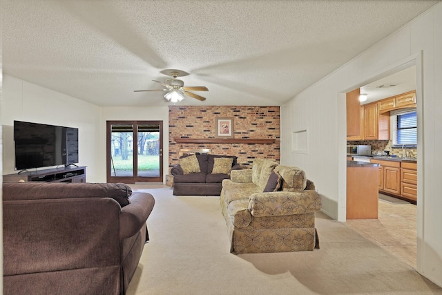 carpeted living room featuring a textured ceiling and ceiling fan