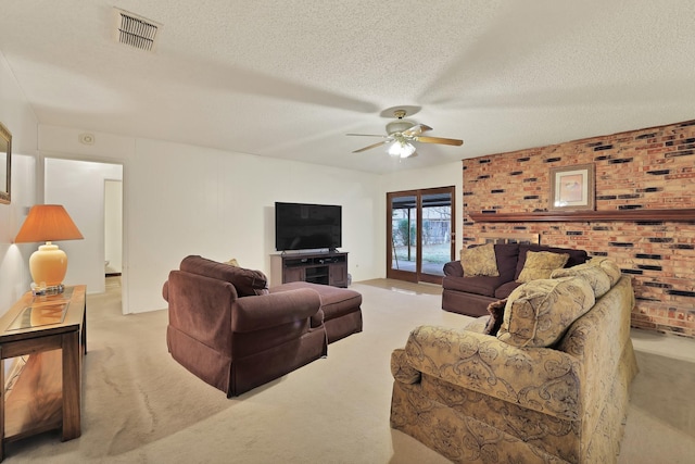 living room featuring a textured ceiling, ceiling fan, and light colored carpet