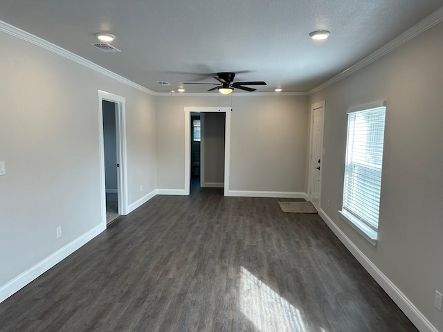 spare room with ceiling fan, a healthy amount of sunlight, dark hardwood / wood-style floors, and ornamental molding