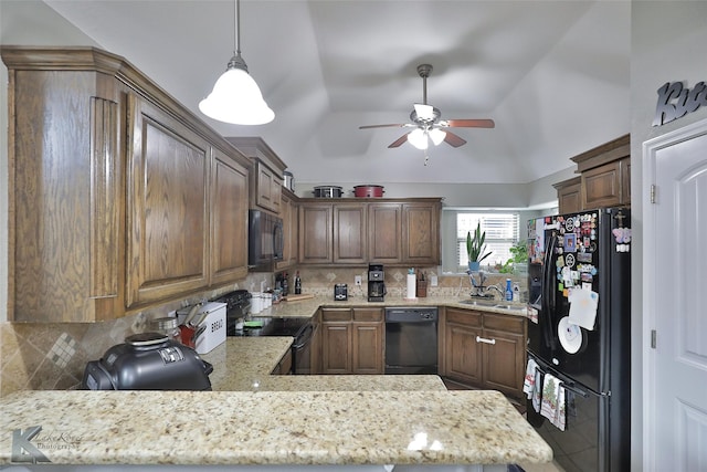 kitchen featuring tasteful backsplash, vaulted ceiling, pendant lighting, black appliances, and kitchen peninsula