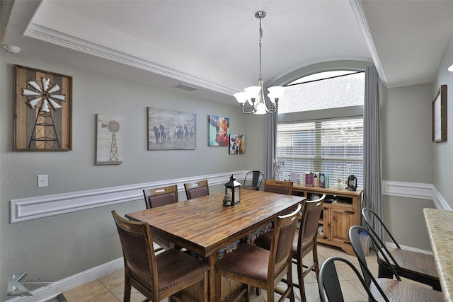 dining space with light tile patterned floors, crown molding, and a chandelier