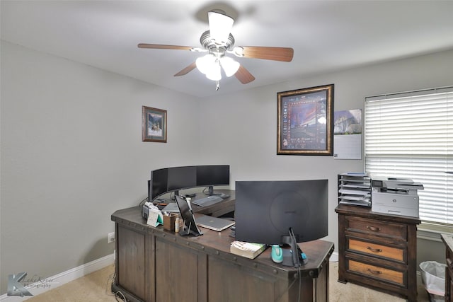 carpeted office space with ceiling fan