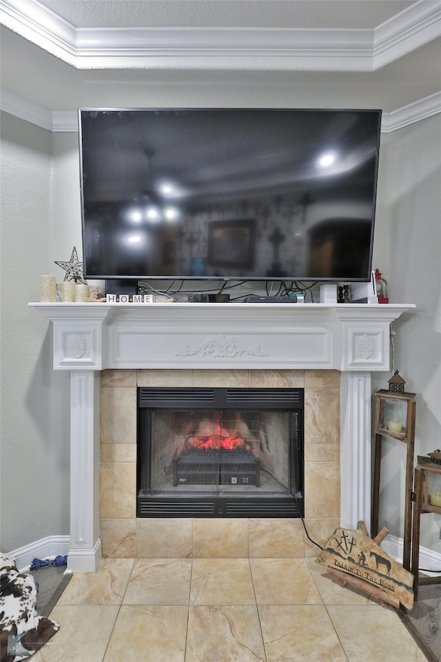 room details featuring a tile fireplace, a tray ceiling, and ornamental molding