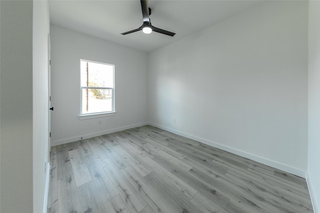 empty room with ceiling fan and light hardwood / wood-style flooring