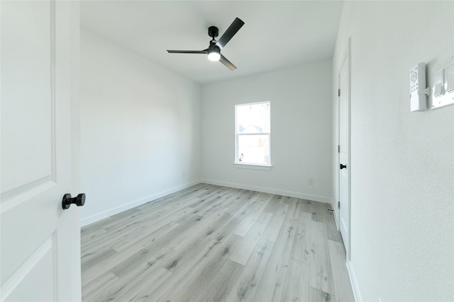 spare room with ceiling fan and light wood-type flooring