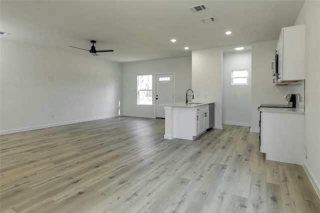 kitchen featuring ceiling fan, sink, white cabinetry, and light hardwood / wood-style flooring