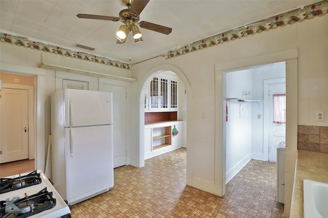 kitchen featuring ceiling fan, sink, white appliances, and washer / clothes dryer