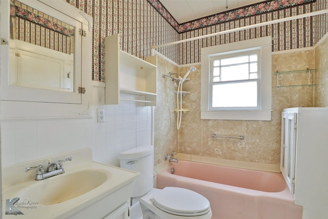 full bathroom featuring toilet, vanity, and tiled shower / bath