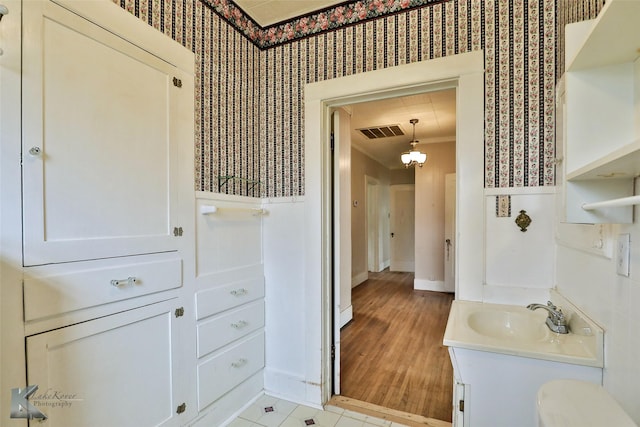 bathroom with ornamental molding, tile patterned floors, and vanity