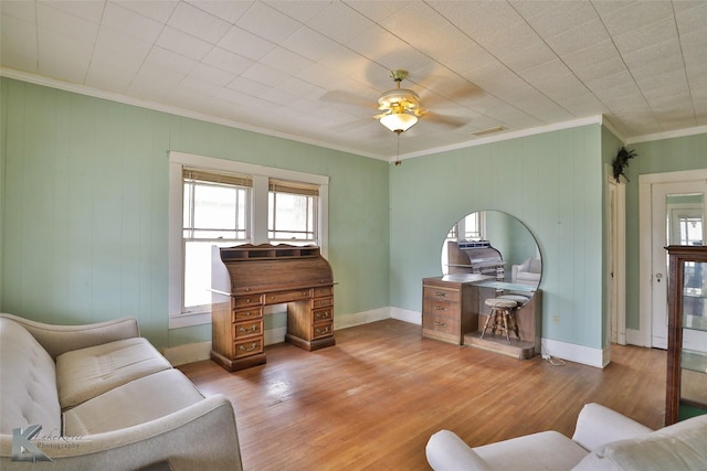 living room with ceiling fan, crown molding, and light hardwood / wood-style floors